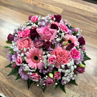 Posy 101 - Mixture of flowers in shades of pink with a to inch of gypsophila 