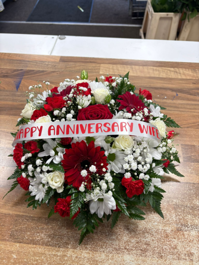 Anniversary Floral Tribute - Beautiful red and white tribute arrangement with rich romantic tones and a personalised ribbon for a heartfelt anniversary remembrance.