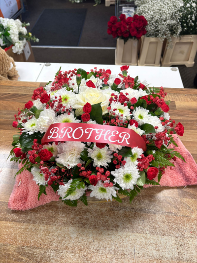 Scarlet & Ivory Tribute Posy - Elegant red and white tribute posy with rich seasonal textures and personalised ribbon for a heartfelt tribute.