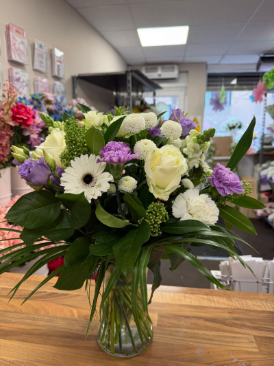 Lavender Whisper Vase - Elegant glass vase arrangement with lavender carnations, white roses and seasonal blooms for a timeless floral gift.